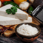 A single shot focusing on grated cotija cheese, illustrating what is cotija cheese in detail, while also hinting at a cotija cheese substitute for those curious about cojita cheese alternatives.